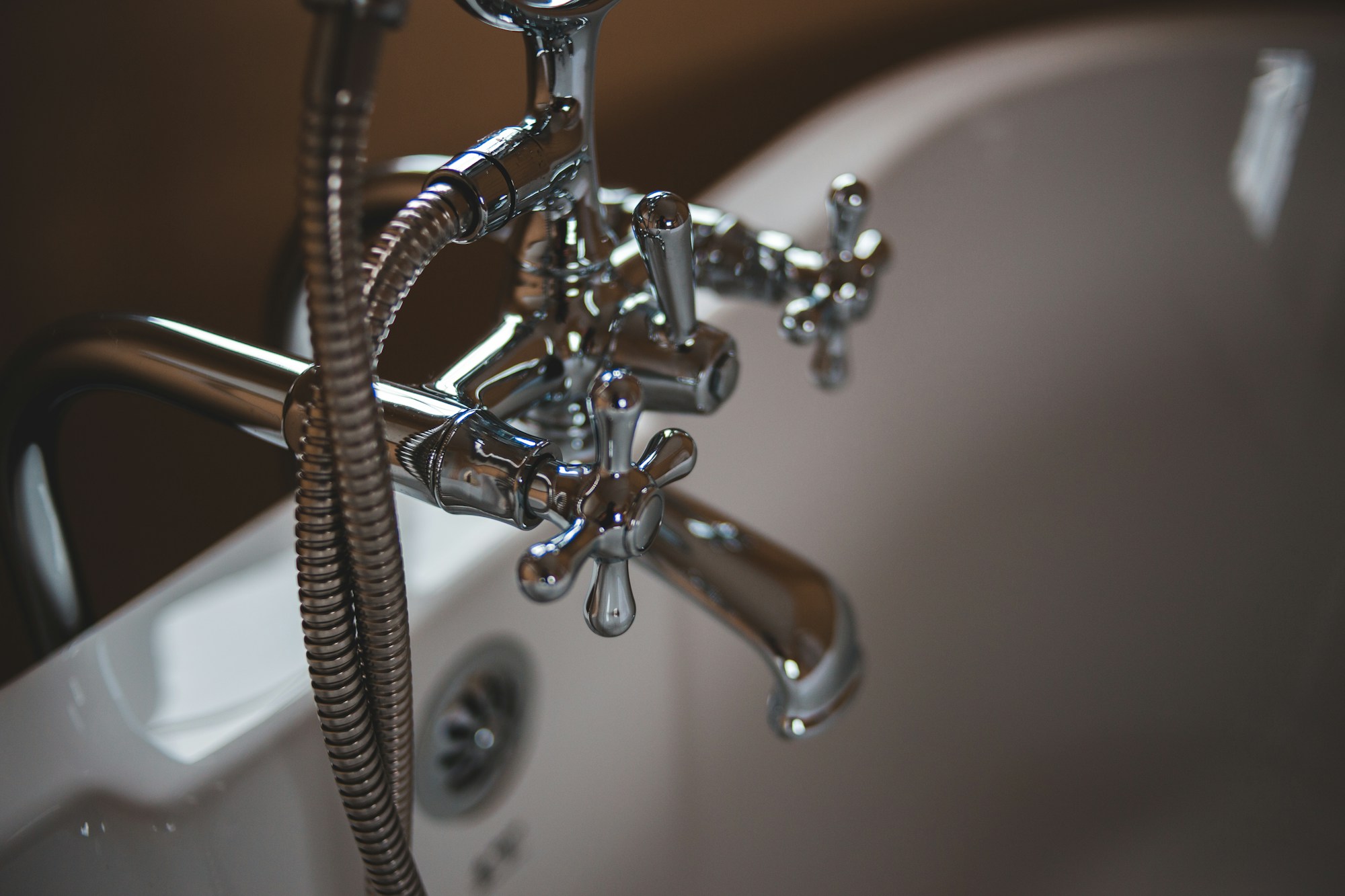 Chrome bath taps and a white bathtub